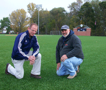 Smith-and-Myaak- Soccer coach Steve Smith, left, and GBK construction manager Jody Myaard on the recently installed synthetic soccer pitch