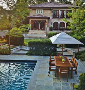 No reservations. The upper-level travertine terrace with custom-designed railings is an ideal place to dine al fresco, offering a view of the gardens and pool.