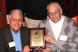 President Jeff Hathorn, left, presents a lifetime achievement award to Ted Collins.