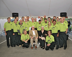 Half-Century mark. Employees of Mark M. Holeman surround company founder Mark Holeman and his wife at the 50th anniversary celebration in June.