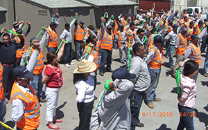 Gachina Landscape Management safety workers are led in morning stretches.
