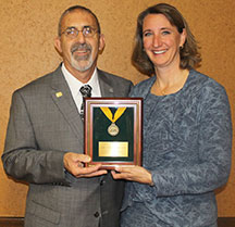 Paula Sliefert, senior marketing manager for Toro, receives a PGMS Gold Medal Award on behalf of the company. Photo: Toro