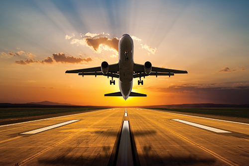 Airplane at sunset. Photo: ©istock.com/guvendemir