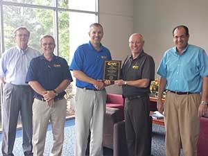 Participating in the Distributor of the Year award presentation are (l to r) Ray Clark, OED vice president of administration; Jim Fenner, OED sales manager; Rob Zucker, OED president; Hal White, Wright vice president of sales; and David Zucker, OED vice president of finance.