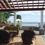 The custom mahogany pergola frames the stunning view across the infinity edge pool.