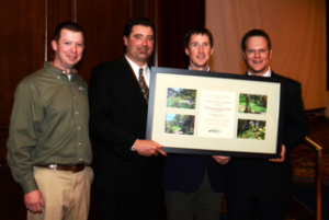 NCNLA President Brad Rollins presents Greenleaf Services with Grand Award and Best in Show.