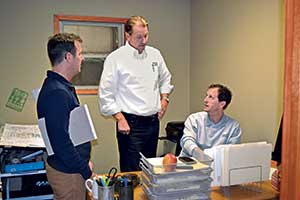 During a Trailblazer visit in 2015, Mike Rorie (center) advised Eric Remeis (left) and his team, including his brother Scott Remeis.