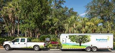 BrightView truck hauling custom designed trailer. (Photo courtesy Beach River Landscapes)
