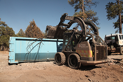 case machine helping cleanup after the fires