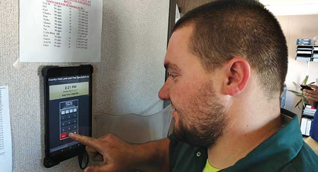 Employee using TimeStation. Photo: Country Club Lawn & Tree Specialists