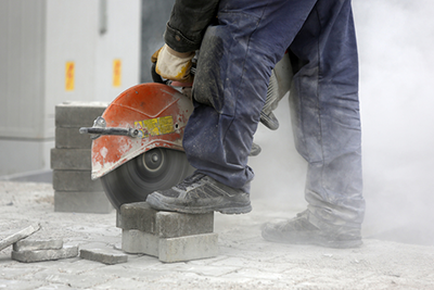 Man cutting concrete pavers