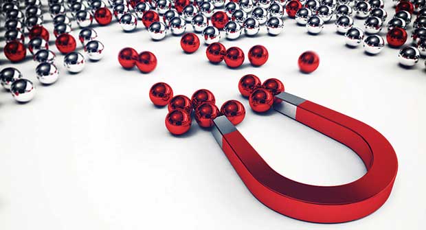 Magnet attracting marbles. Illustration: iStock.com/alphaspirit
