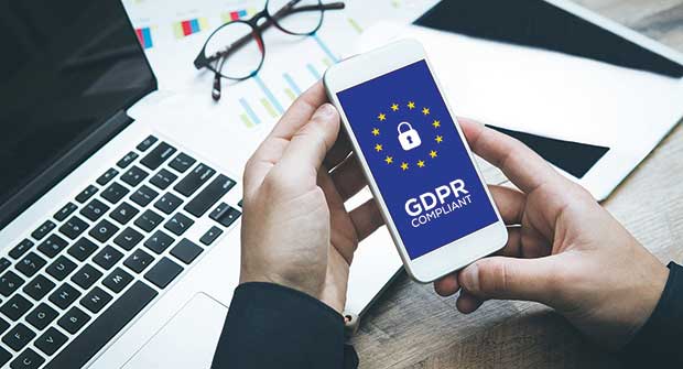 hands holding phone with GDPR notes. photo illustration: iStock.com/cnythzl