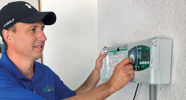 Man setting irrigation system