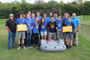School board members, Echo employees and Lake Zurich High School students pose with Echo's autonomous mower at the test site in Lake Zurich, Ill. | Photo: Echo