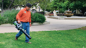 Man with battery-powered blower (Photo: American Green Zone Alliance)