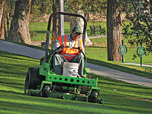 Man on battery-powered mower (Photo: American Green Zone Alliance)
