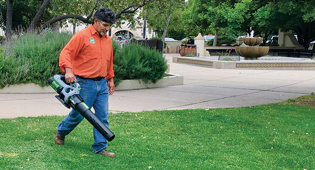 Man with battery-powered blower (Photo: American Green Zone Alliance)