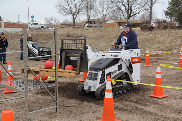 a student operating a skid-steer loader (Photo: Seth Jones)