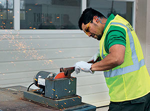 Crew member sharpening blades (Photo: Ruppert Landscape)