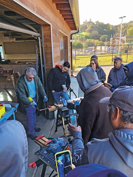 Gachina Landscape Management team members watch a demonstration by Frank Niccoli at Foothill College’s John Paul and H. Jaclyn Ishimaru-Gachina Learning Center. Photo: Chad Sutton, Gachina Landscape Management