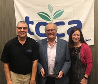 TOCA Executive Director Den Gardner (left) and Project EverGreen Executive Director Cindy Code (right) present Norman Goldenberg with the 2019 Environmental Communicator Award. PHOTO: PROJECT EVERGREEN