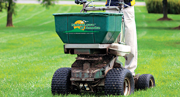 Man performing lawn care services (Photo: Naturalawn of America)