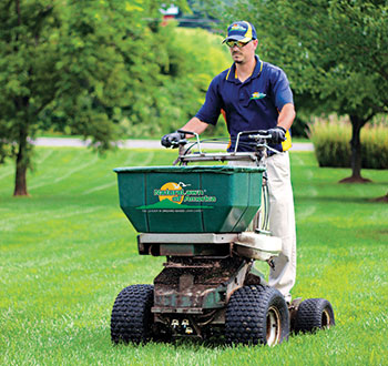 Man performing lawn care services (Photo: Naturalawn of America)