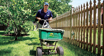 Person using spreader (Photo: NaturaLawn of America)