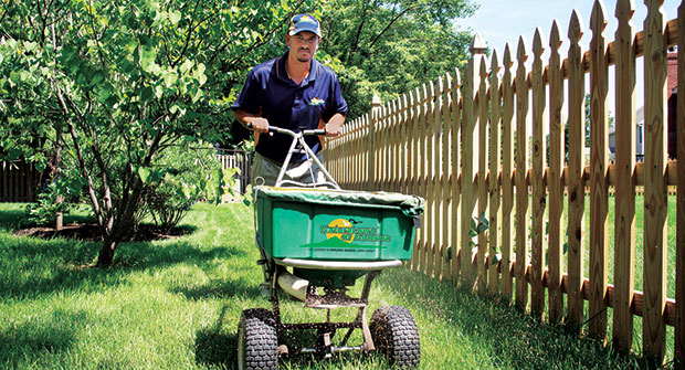Person using spreader (Photo: NaturaLawn of America)