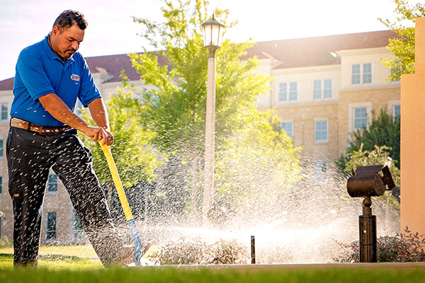 Crew member working on irrigation project (Photo: Andy's Sprinkler, Drainage & Lighting)