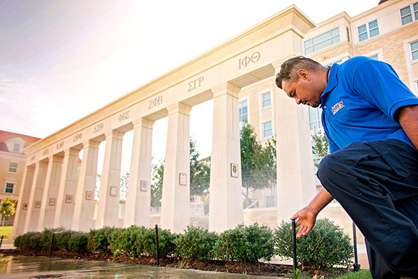 Crew member checking sprayhead (Photo: Andy's Sprinkler, Drainage & Lighting)