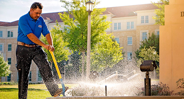 Crew member working at TCU (Photo: Andy's Sprinkler, Drainage & Lighting)