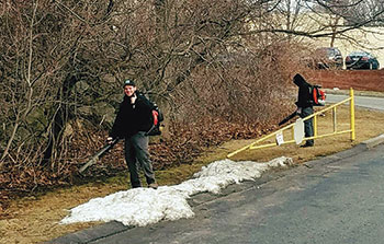 Sometimes, JC Grounds Management starts spring cleanups despite slight snow cover. (Photo: JC Grounds Management)