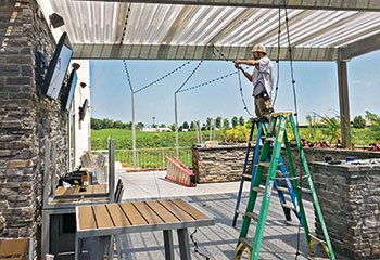 Man putting up lighting (Photo: McKay Lighting)