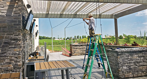 Man putting up lighting (Photo: McKay Lighting)