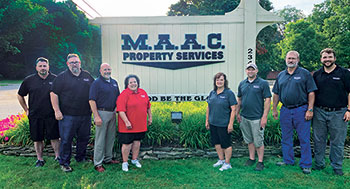 Schlutt, pictured on the far right, says the company values second chances. (Photo: MAAC Property Services)