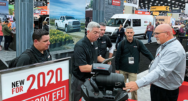 Darrell Hyde shows off Kawasaki Motors Corp.’s new FX 100 EFI engine to LM’s Dan Hannan, Seth Jones, Craig MacGregor and Bill Roddy. (Photo: LM Staff)