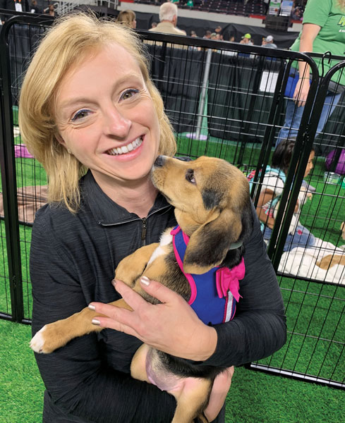 They call it puppy love LM Editor Christina Herrick got her puppy fix during Lucky’s Mutt Madness adoption event. TurfMutt Foundation partnered with the Kentucky Humane Society to find homes for dogs and puppies alike during GIE+EXPO. (Photo: LM Staff)
