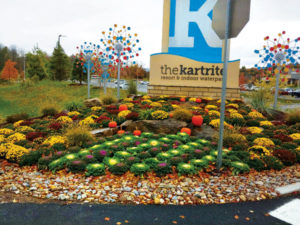 Wagner Landscaping tends to the Kartrite Resort & Indoor Waterpark's outdoor property as well. Annuals are planted at the front entrance sign each season, like this display of mums with some pumpkins. (Photo: Steven Wagner)