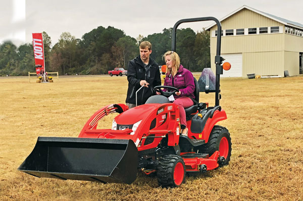 Kioti’s Greg Bibee gives LM’s Sarah Webb the rundown on Kioti’s CS2210 tractor. (Photo: Kioti)