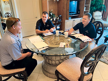 Partners meeting with lawn care operator (Photo: Christina Herrick)
