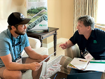 Partner and lawn care operator chatting (Photo: Christina Herrick)