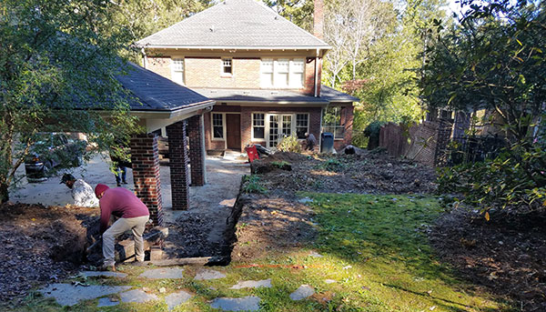 Crews removing railroad ties and stone steps (Photo: Plants Creative Landscapes)