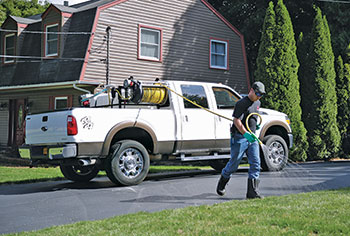 Lawn care operator spraying a lawn (Photo: Gregson-Clark Spraying Equipment)