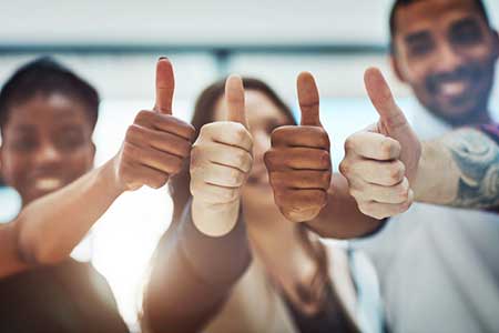 Employees giving thumb's up (Photo: PeopleImages/E+/Getty Images)