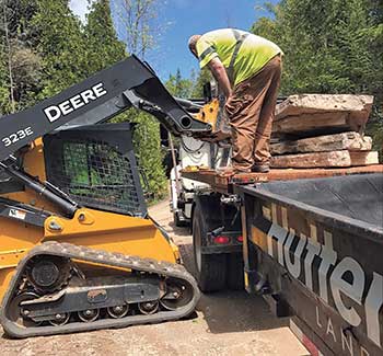 Hutten & Co. crew member and John Deere equipment (Photo: Hutten & Co. Land and Shore)
