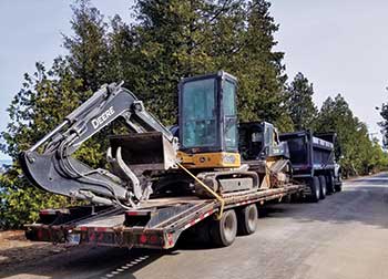 Hutten & Co. crew member and John Deere equipment (Photo: Hutten & Co. Land and Shore)