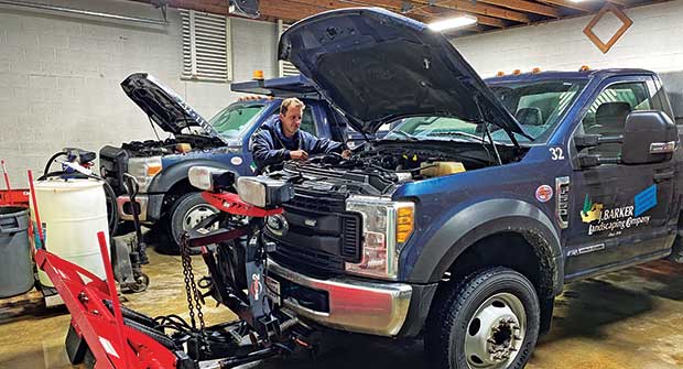 Mechanic performing fleet maintenance (Photo: J. Barker Landscaping Co.)