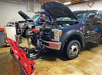 Mechanic performing fleet maintenance (Photo: J. Barker Landscaping Co.)